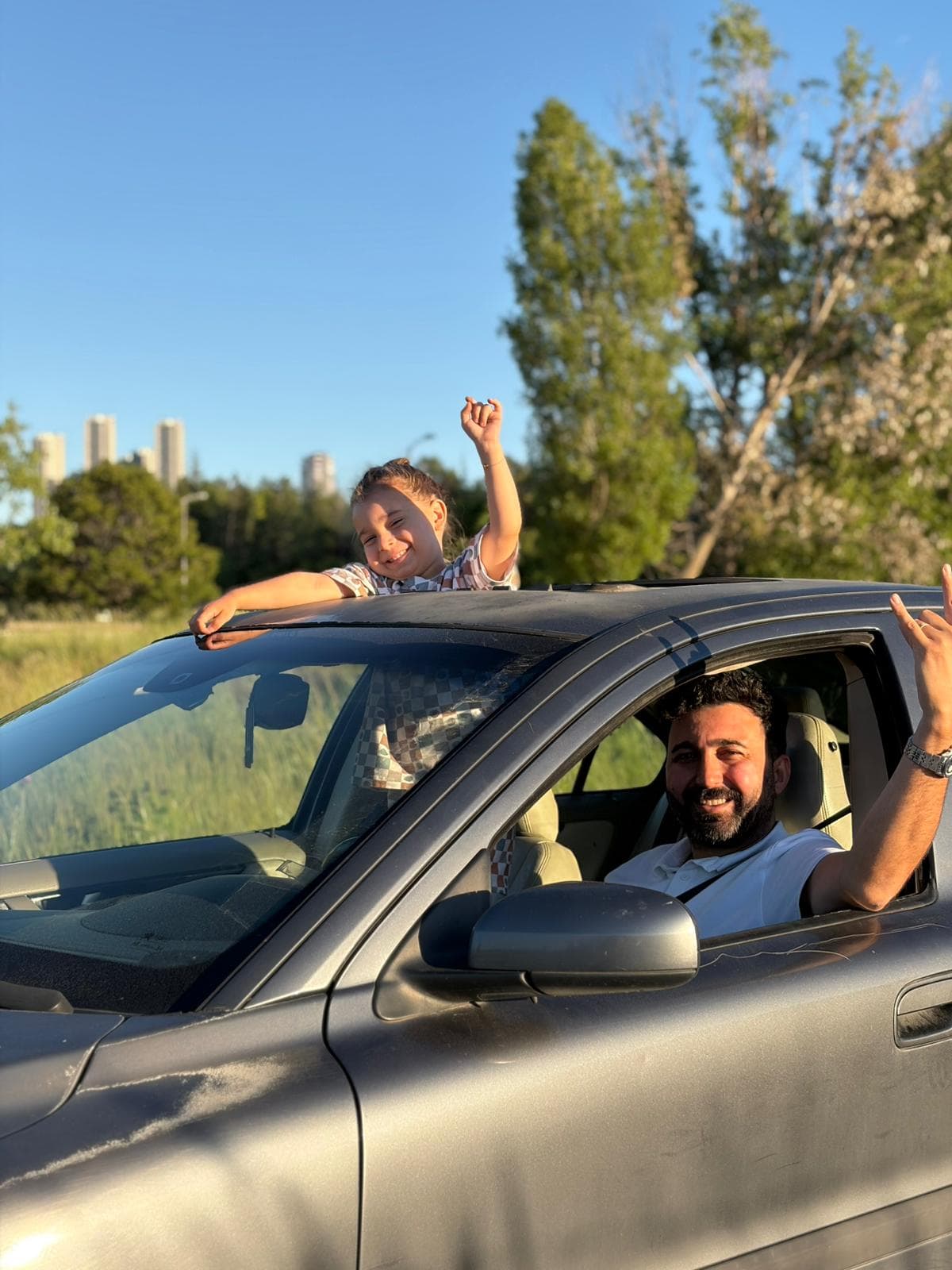 Family moment with a child looking out from Bay V's sunroof